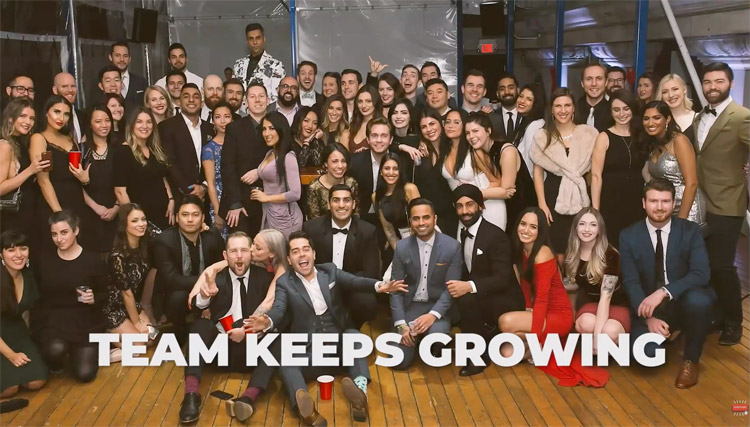 A group photo of a few dozen people in formal wear with the words "TEAM KEEPS GROWING" superimposed.